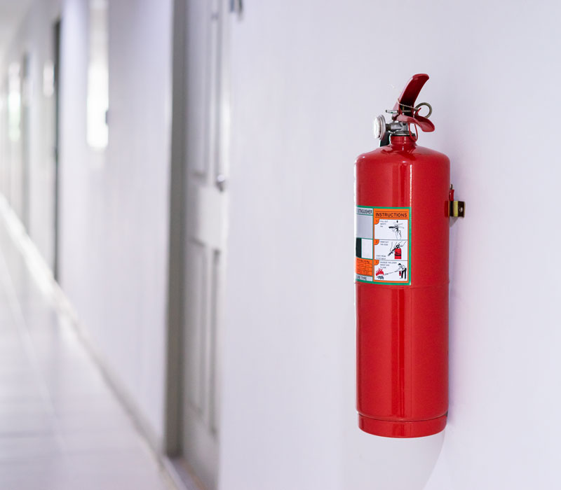 fire extinguisher on the wall of commercial building