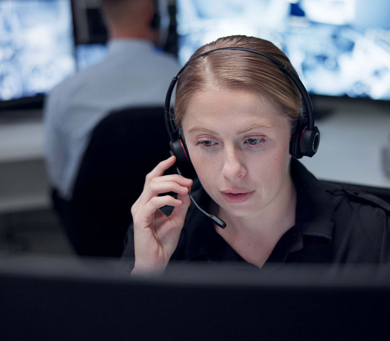 woman with headset sitting in front of monitor
