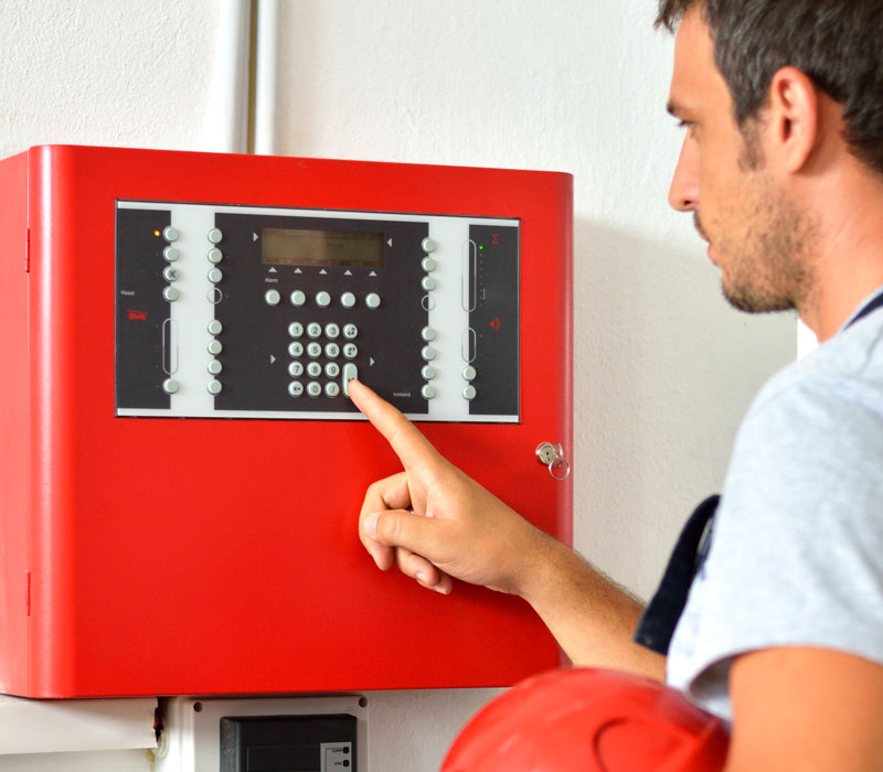 man checking emergency monitoring system in building